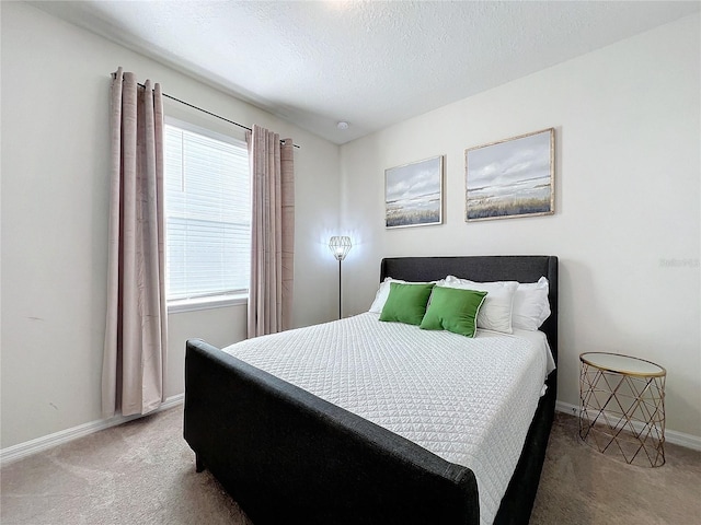 bedroom with a textured ceiling and carpet