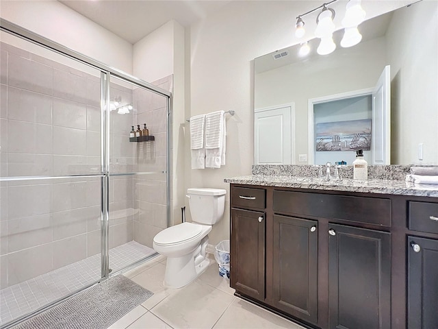 bathroom featuring tile patterned floors, an enclosed shower, vanity, and toilet