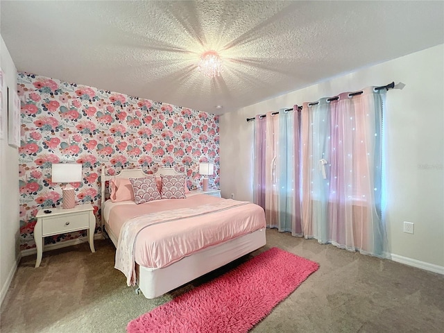 bedroom featuring multiple windows, a textured ceiling, and carpet floors