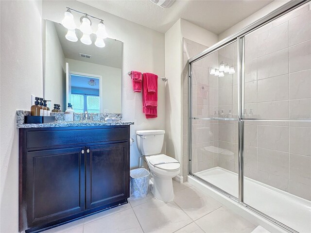 bathroom with an enclosed shower, vanity, and toilet