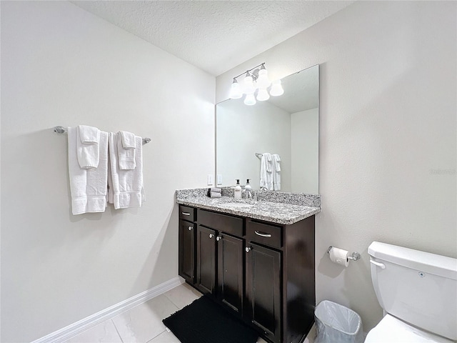 bathroom featuring vanity, toilet, and a textured ceiling