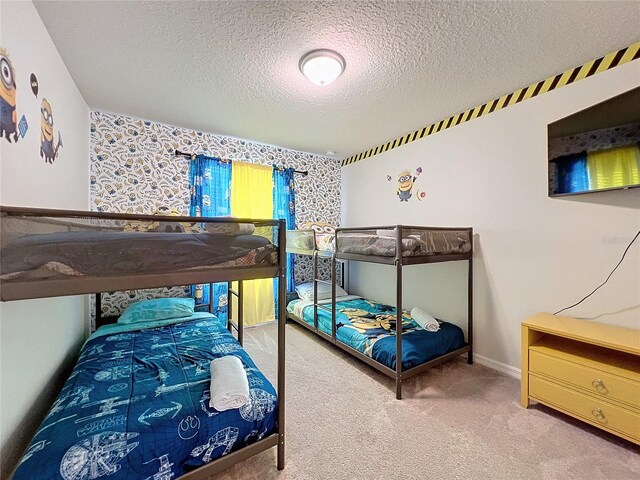 bedroom featuring a textured ceiling and carpet flooring