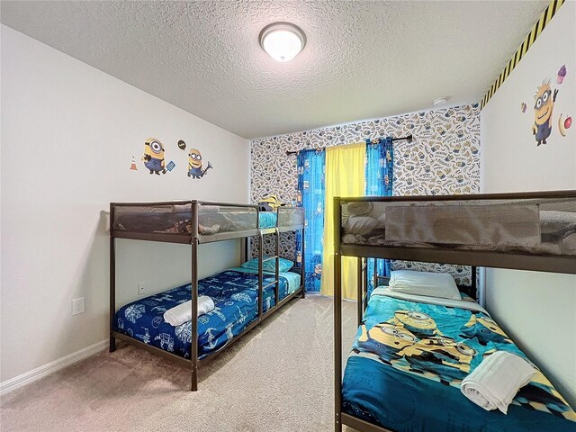 carpeted bedroom with a textured ceiling