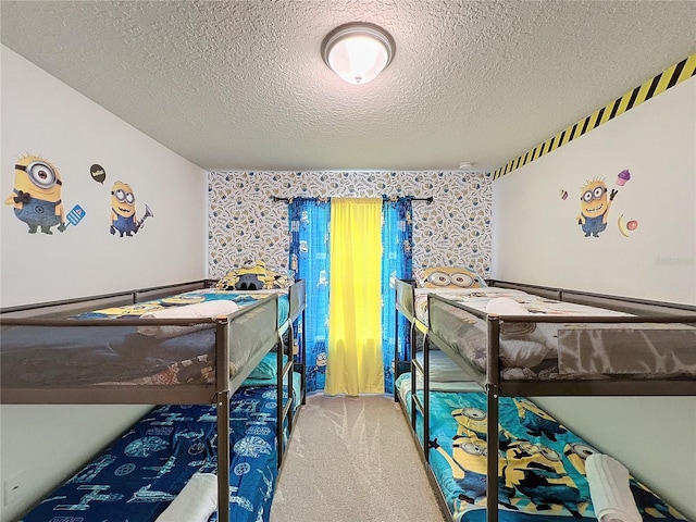 bedroom featuring a textured ceiling and carpet flooring