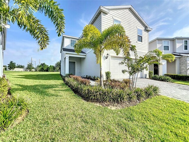 view of side of property with a lawn and a garage