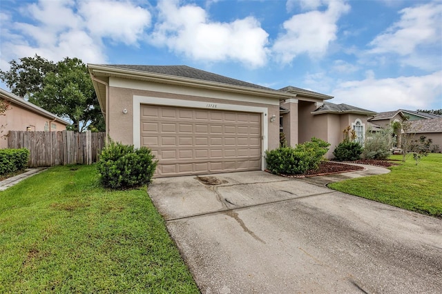 view of front of home featuring a front yard and a garage