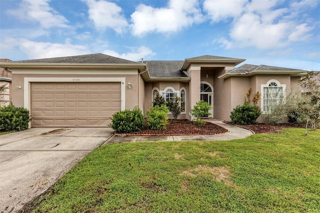 view of front facade with a garage and a front yard