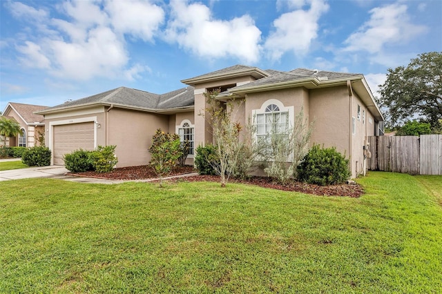 view of front of property featuring a garage and a front lawn