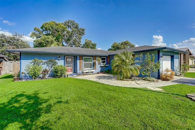 ranch-style home featuring a garage and a front lawn