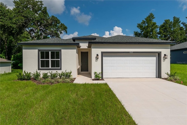 prairie-style house with a garage and a front lawn