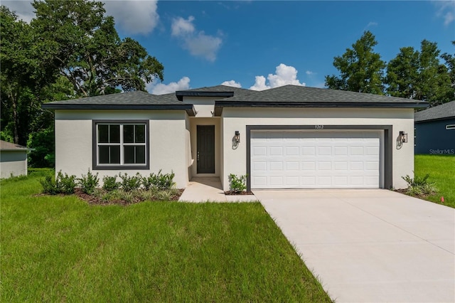 view of front of property with a front yard, concrete driveway, stucco siding, and an attached garage