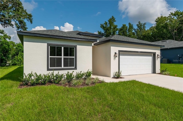 view of front of house featuring driveway, a front yard, central air condition unit, stucco siding, and a garage