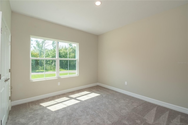empty room with carpet floors, baseboards, and recessed lighting