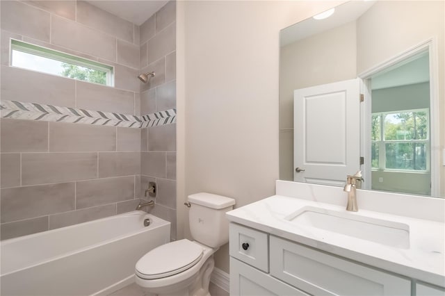 bathroom featuring shower / bathing tub combination, toilet, and vanity
