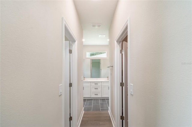 hall featuring visible vents and wood finish floors
