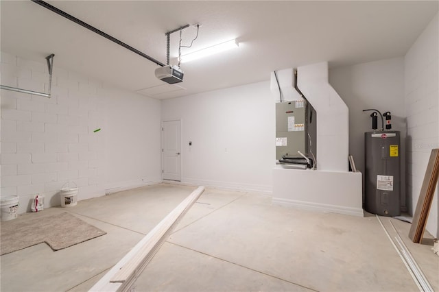 garage with heating unit, water heater, concrete block wall, and a garage door opener