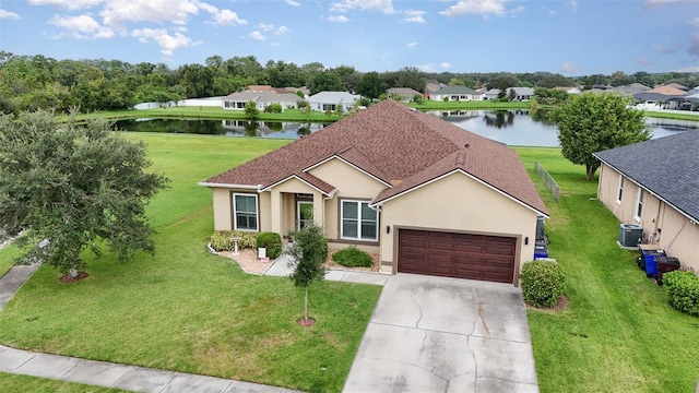 ranch-style house featuring cooling unit, a water view, a front lawn, and a garage