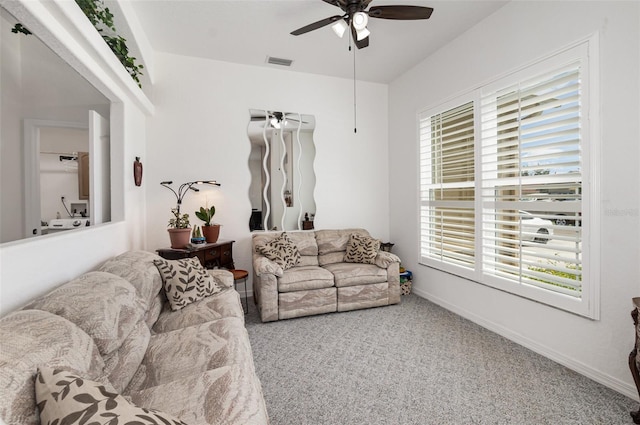 living room featuring carpet flooring, ceiling fan, and plenty of natural light