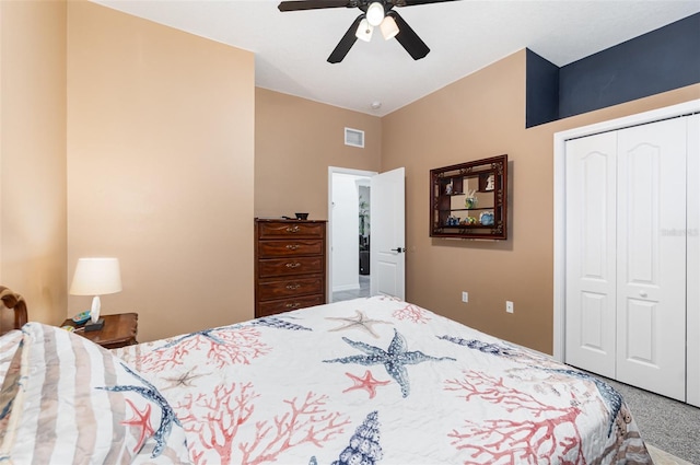 carpeted bedroom featuring a closet and ceiling fan