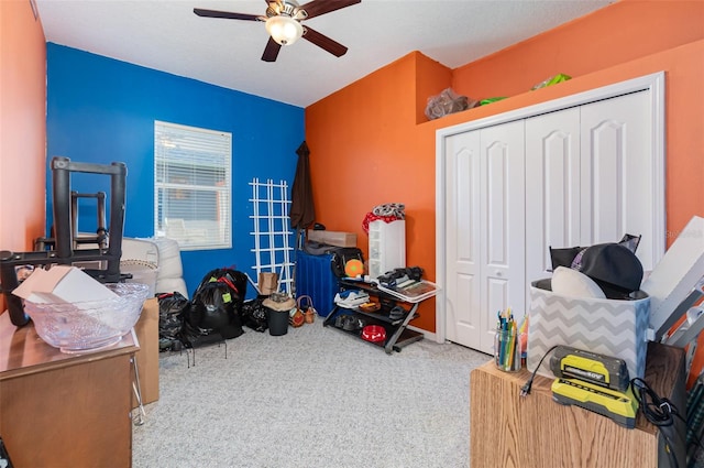 interior space with ceiling fan and a closet