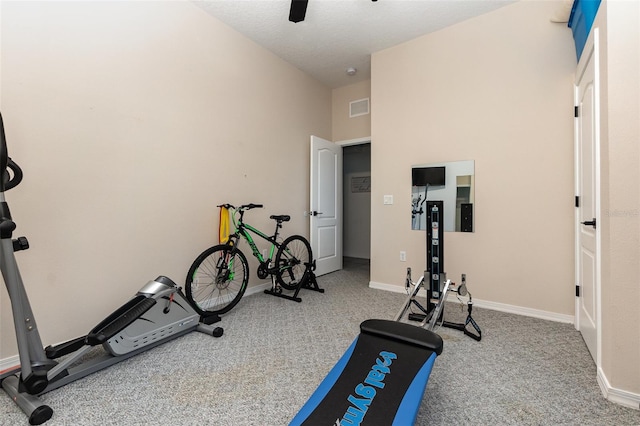 workout room with carpet, a high ceiling, and ceiling fan