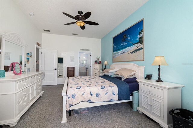 carpeted bedroom with ceiling fan and ensuite bathroom