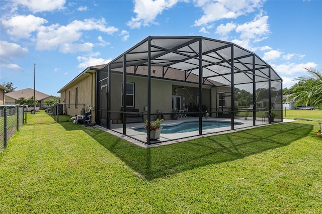 rear view of property with a lawn, a patio, a fenced in pool, and glass enclosure