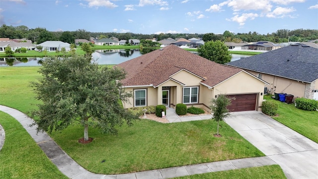 single story home featuring a water view, a front yard, and a garage