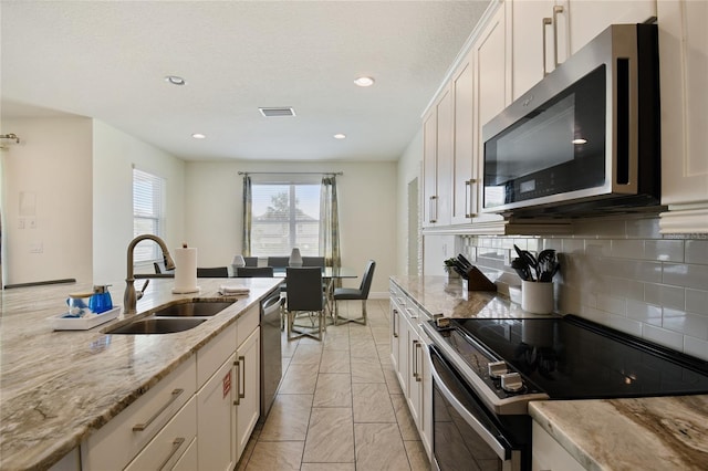 kitchen with white cabinets, stainless steel appliances, and sink