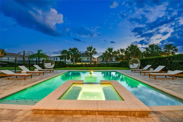 view of pool featuring a patio and an in ground hot tub