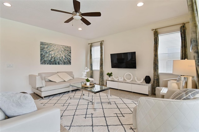 living room featuring ceiling fan and plenty of natural light