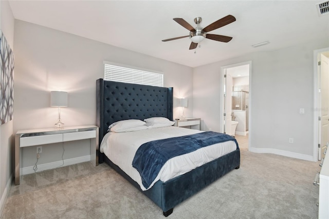 carpeted bedroom featuring connected bathroom and ceiling fan