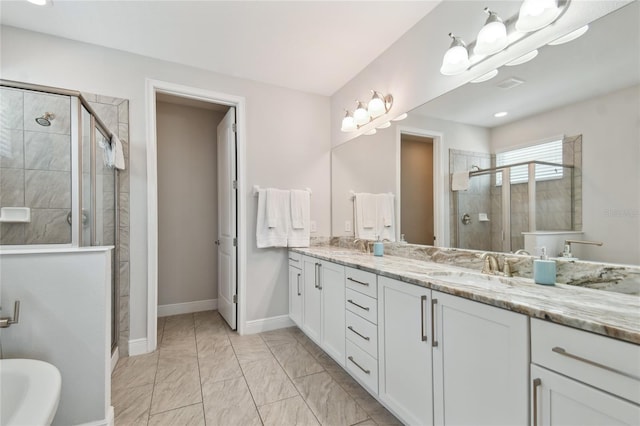 bathroom featuring vanity and a shower with shower door