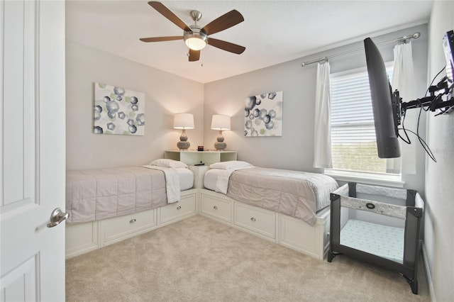 bedroom with ceiling fan and light colored carpet