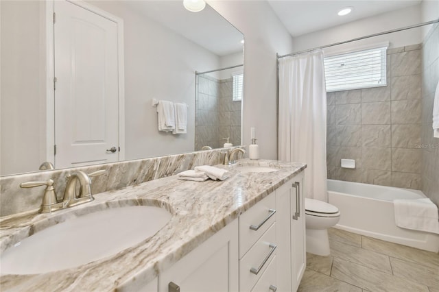 full bathroom featuring tile patterned floors, shower / bath combo, vanity, and toilet