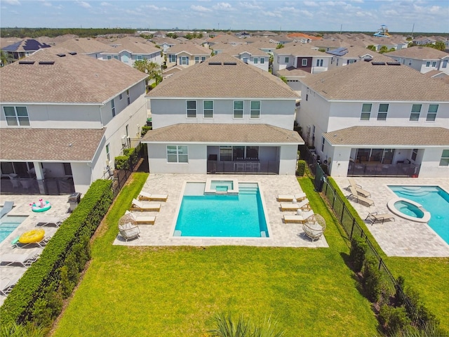 view of pool featuring a lawn, a sunroom, an in ground hot tub, and a patio area