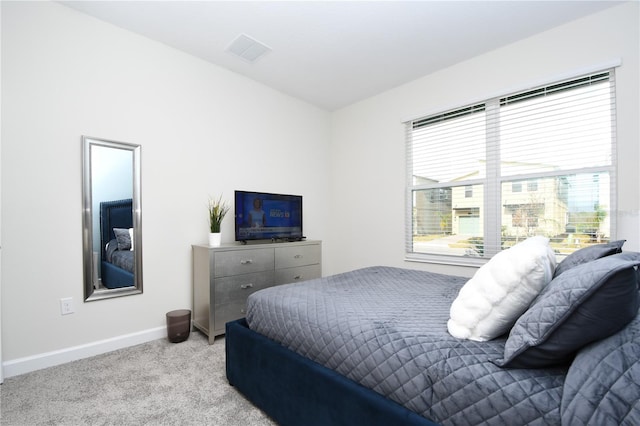 bedroom featuring light colored carpet