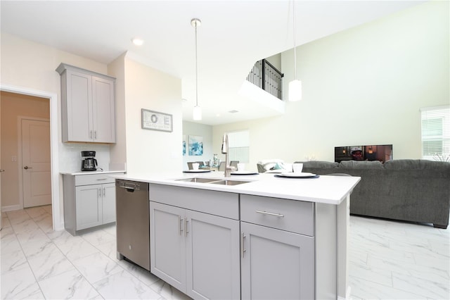 kitchen featuring gray cabinets, dishwasher, hanging light fixtures, and a kitchen island with sink