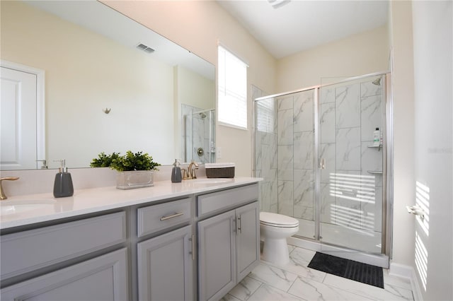 bathroom with vanity, a shower with shower door, and toilet