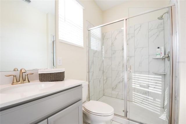 bathroom with an enclosed shower, vanity, and toilet