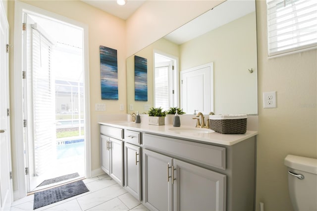 bathroom with vanity, toilet, and plenty of natural light