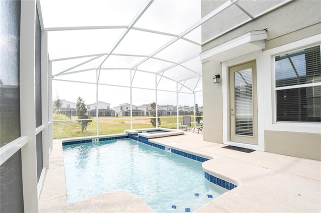 view of swimming pool with a patio, an in ground hot tub, and glass enclosure