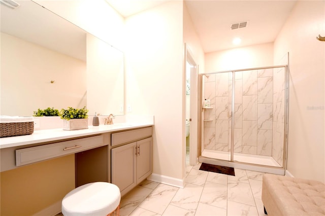 bathroom with vanity, a shower with shower door, and toilet