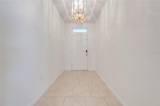 doorway with light tile patterned flooring and a notable chandelier