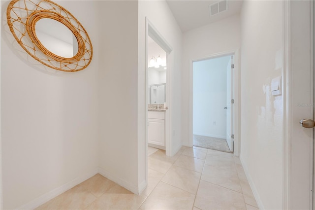 hall with light tile patterned floors