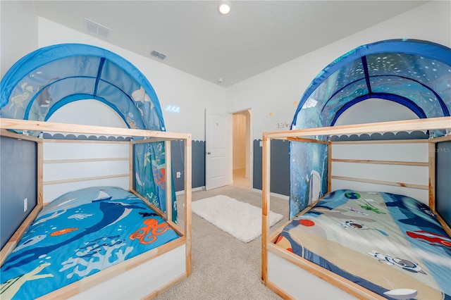 bedroom featuring light colored carpet and lofted ceiling