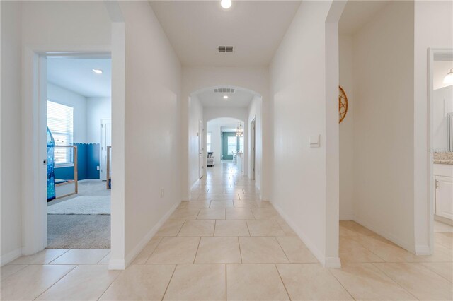 corridor with light tile patterned flooring