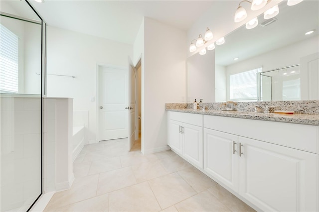 bathroom featuring tile patterned floors, independent shower and bath, and vanity