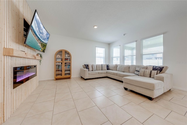 unfurnished living room with light tile patterned flooring and a textured ceiling