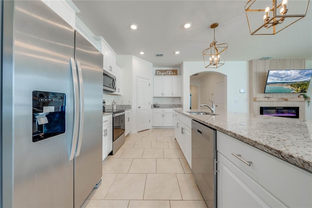 kitchen with white cabinetry, appliances with stainless steel finishes, and hanging light fixtures